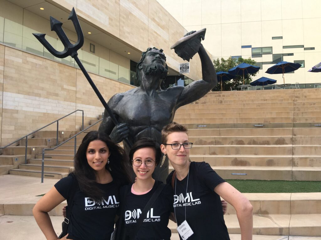 Three students from the Digital Music Lab posing in front of a statue of Poseidon in San Diego.